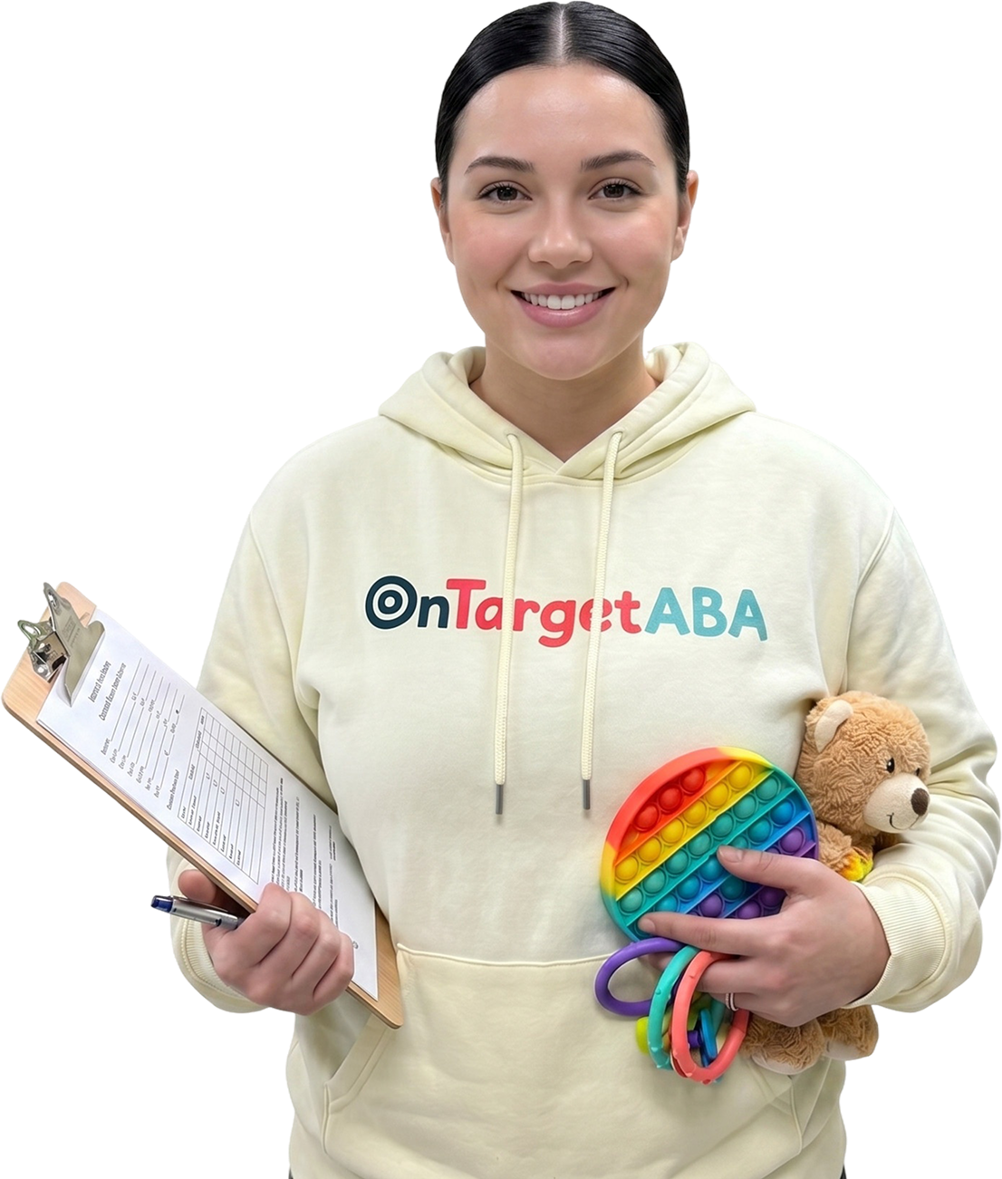 Smiling woman wearing an OnTarget ABA hoodie holding a clipboard, a stuffed bear, and a toy.